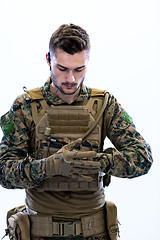 Image showing closeup of soldier hands putting protective battle gloves
