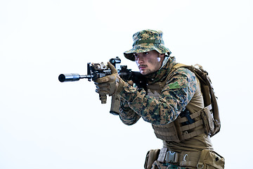 Image showing soldier in action aiming laseer sight optics