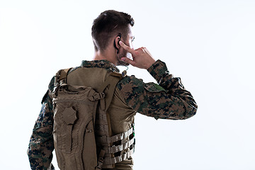 Image showing soldier preparing gear for action and checking communication