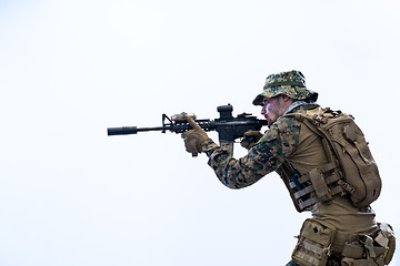 Image showing soldier in action aiming laseer sight optics