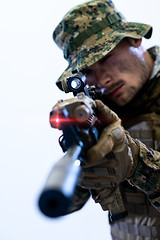 Image showing soldier in action aiming laseer sight optics