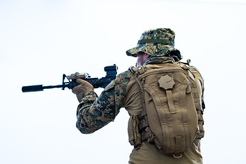 Image showing soldier in action aiming laseer sight optics