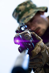 Image showing soldier in action aiming laseer sight optics