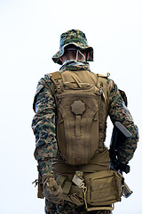 Image showing soldier going in battle rear view