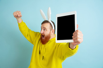 Image showing Easter bunny man with bright emotions on blue studio background