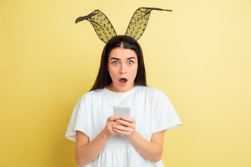 Image showing Easter bunny woman with bright emotions on yellow studio background