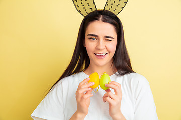 Image showing Easter bunny woman with bright emotions on yellow studio background