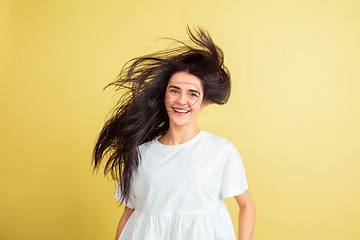 Image showing Easter bunny woman with bright emotions on yellow studio background