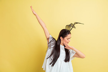 Image showing Easter bunny woman with bright emotions on yellow studio background