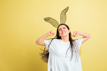 Image showing Easter bunny woman with bright emotions on yellow studio background