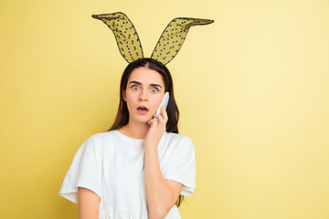 Image showing Easter bunny woman with bright emotions on yellow studio background