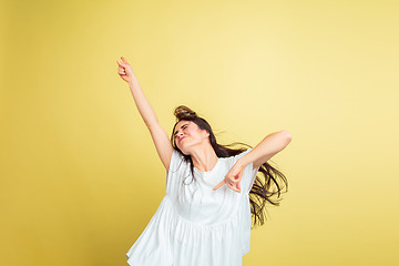 Image showing Easter bunny woman with bright emotions on yellow studio background