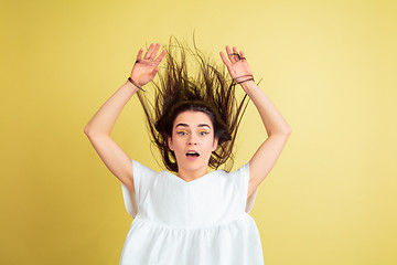 Image showing Easter bunny woman with bright emotions on yellow studio background