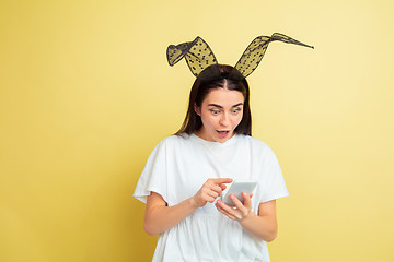 Image showing Easter bunny woman with bright emotions on yellow studio background