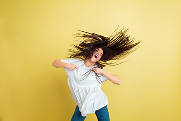 Image showing Easter bunny woman with bright emotions on yellow studio background