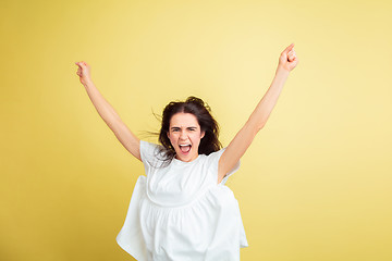 Image showing Easter bunny woman with bright emotions on yellow studio background