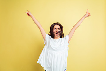 Image showing Easter bunny woman with bright emotions on yellow studio background