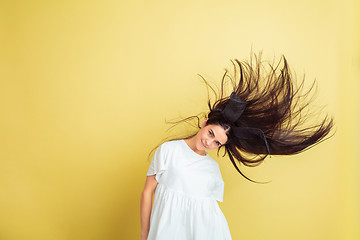 Image showing Easter bunny woman with bright emotions on yellow studio background