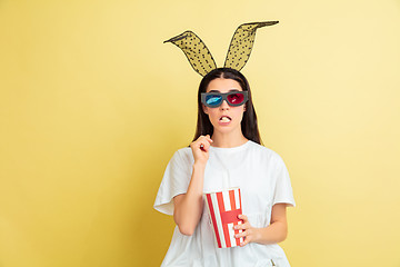 Image showing Easter bunny woman with bright emotions on yellow studio background