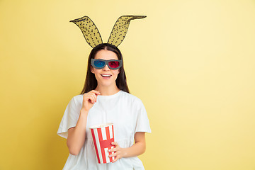 Image showing Easter bunny woman with bright emotions on yellow studio background