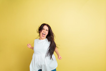 Image showing Easter bunny woman with bright emotions on yellow studio background