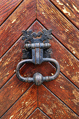 Image showing Vintage doorknocker close-up on wooden door background