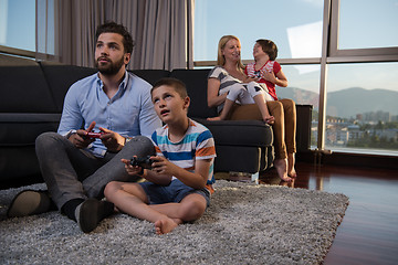 Image showing Happy family playing a video game