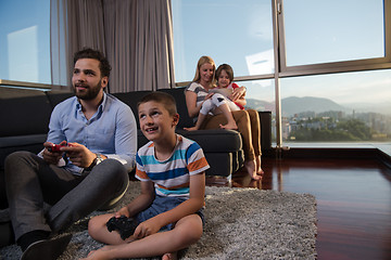 Image showing Happy family playing a video game