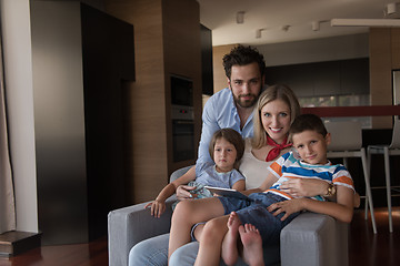 Image showing happy young couple spending time with kids