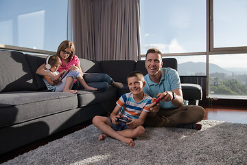 Image showing Happy family playing a video game