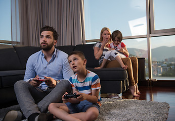 Image showing Happy family playing a video game