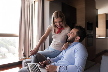 Image showing couple relaxing at  home using laptop computers