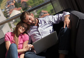 Image showing couple relaxing at  home using laptop computers