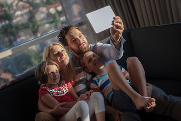 Image showing happy young couple spending time with kids at home