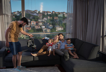 Image showing happy young couple spending time with kids at home