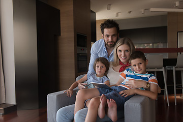 Image showing happy young couple spending time with kids