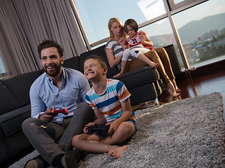 Image showing Happy family playing a video game