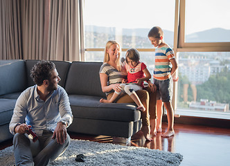 Image showing Happy family playing a video game