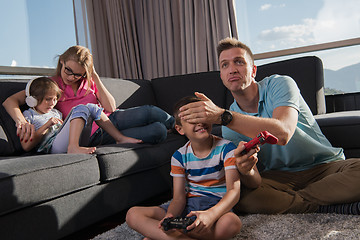 Image showing Happy family playing a video game