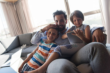 Image showing happy young father spending time with kids