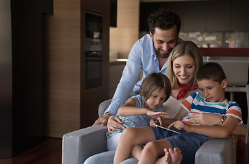 Image showing happy young couple spending time with kids