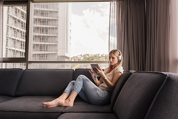 Image showing young girl enjoying music through headphones