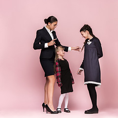 Image showing Cute stylish children on pink studio background. The beautiful teen girls standing together