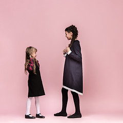 Image showing Cute stylish children on pink studio background. The beautiful teen girls standing together