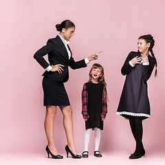 Image showing Cute stylish children on pink studio background. The beautiful teen girls standing together