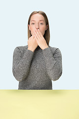 Image showing Young woman covering her mouth