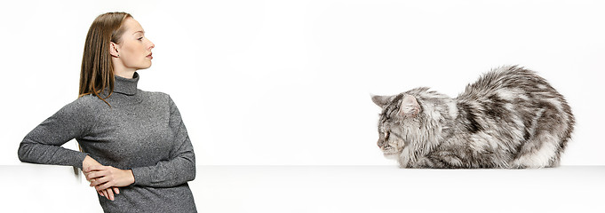 Image showing Woman with her cat over white background