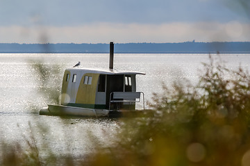 Image showing Floating sauna with seagul in the sea.