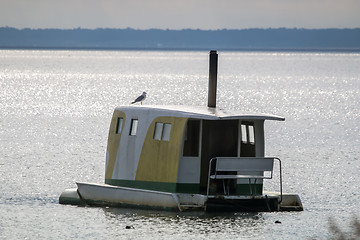 Image showing Floating sauna with seagul in the sea.