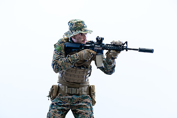 Image showing soldier in action aiming laseer sight optics